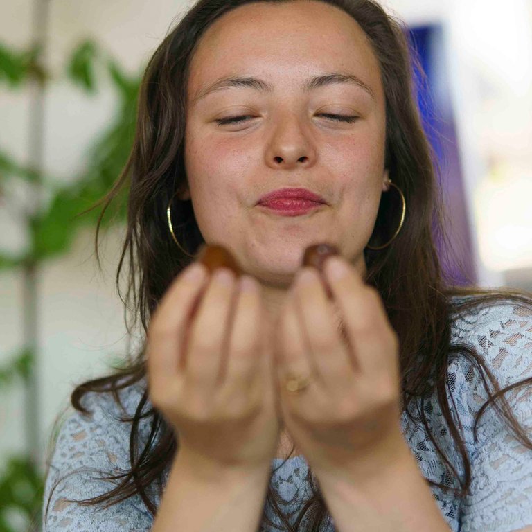 woman chooses between two fresh dates